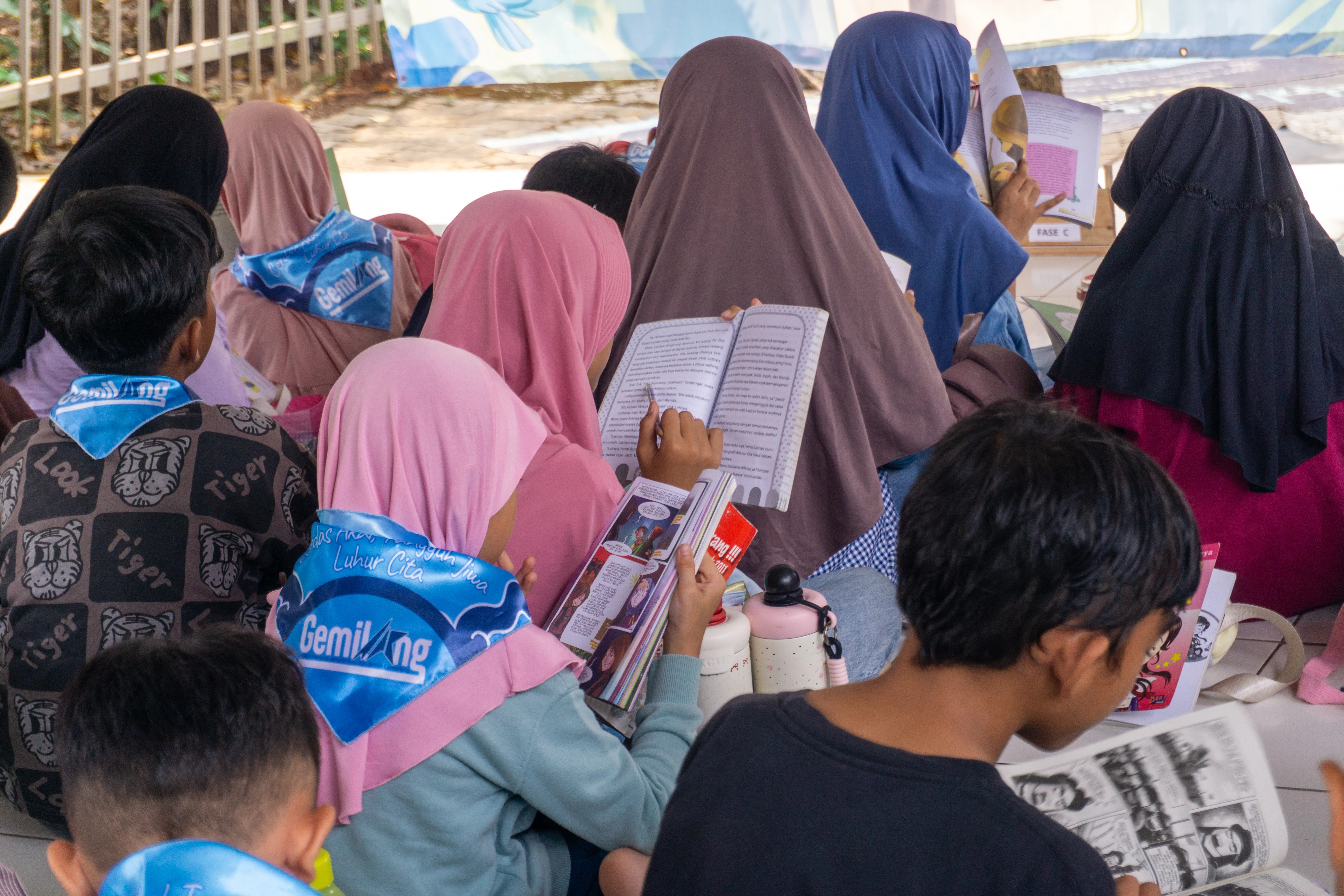 Anak-anak mengangkat tangan menjawab pertanyaan di kelas teras